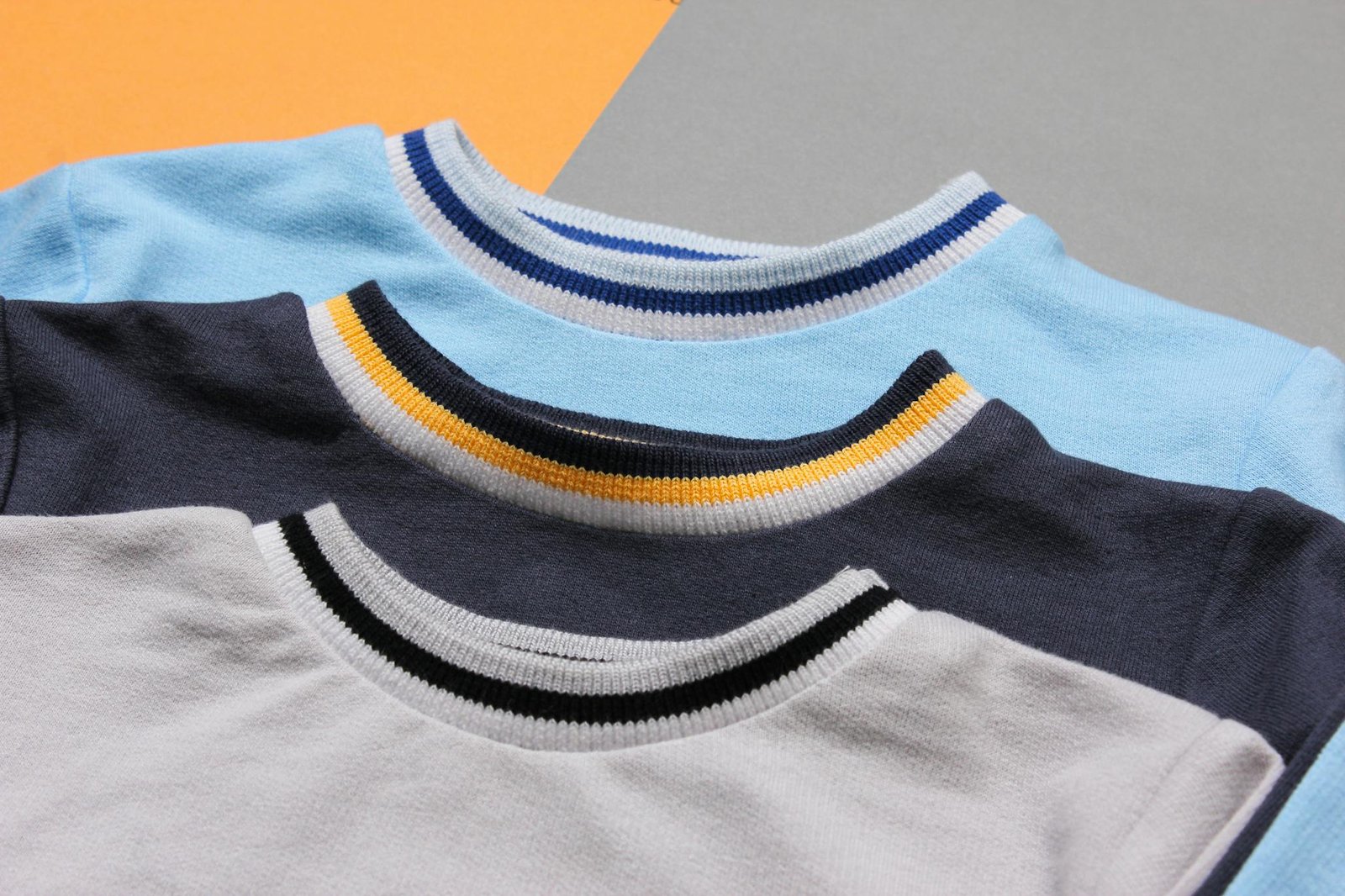 A collection of vibrant crewneck sweaters arranged on a flat surface, ideal for fashion themes.